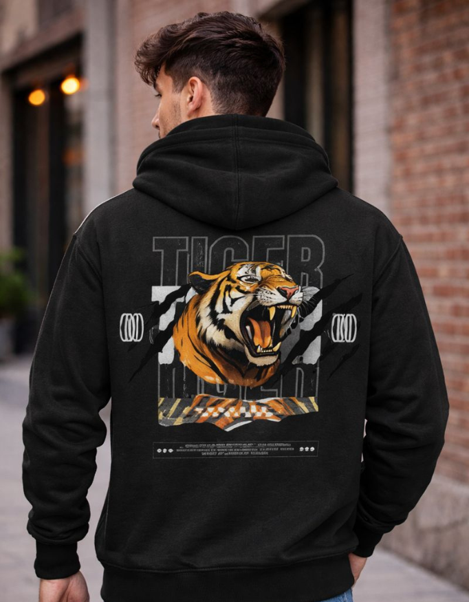 Person wearing a black hoodie with a tiger graphic on the back, standing in an urban setting.